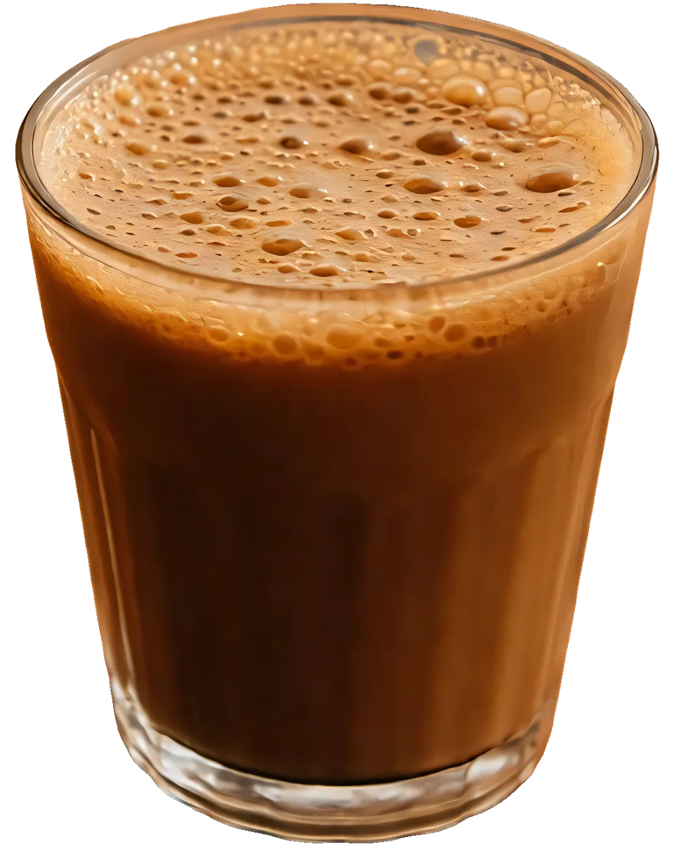 A cutting-chai glass filled to the brim with frothy chai